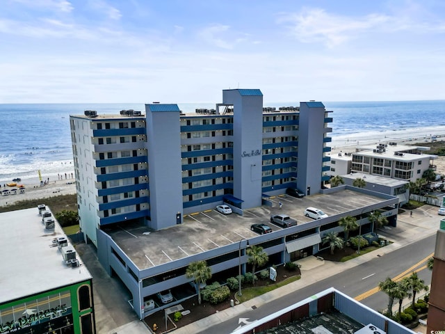 birds eye view of property featuring a water view and a view of the beach