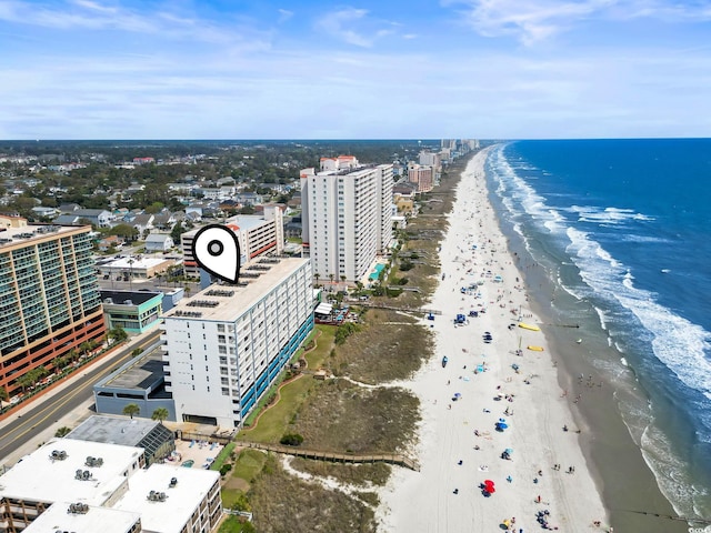 drone / aerial view with a water view and a beach view