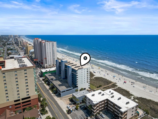 drone / aerial view featuring a water view and a beach view