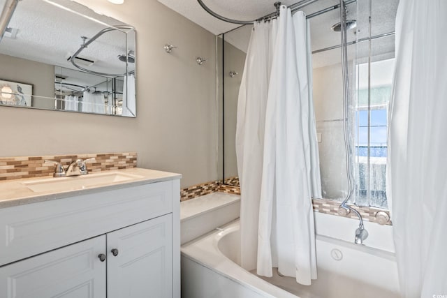 bathroom featuring a textured ceiling, backsplash, vanity, and shower / bathtub combination with curtain