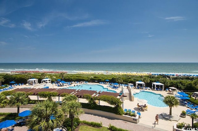 exterior space with a community pool, a patio, a beach view, and a water view