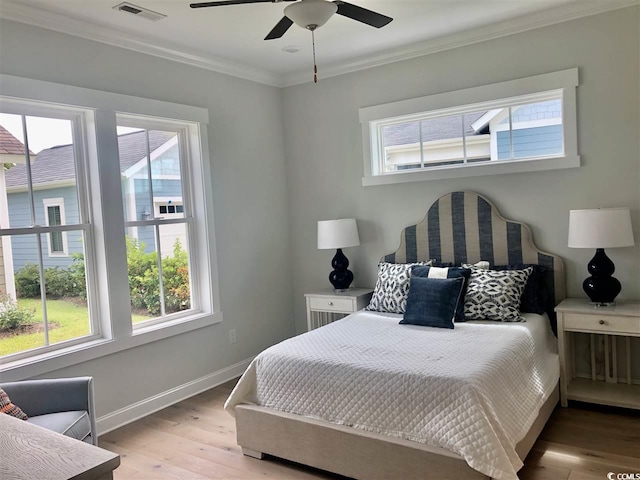 bedroom featuring crown molding, ceiling fan, and light hardwood / wood-style flooring