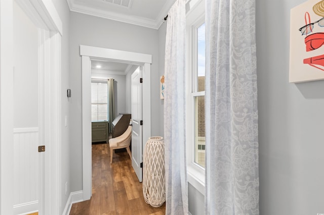 hall featuring wood-type flooring and ornamental molding