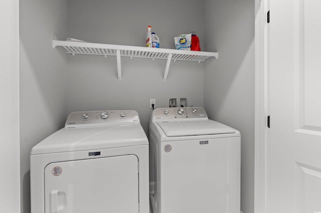 clothes washing area featuring washing machine and dryer