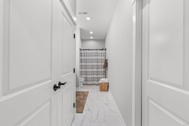 bathroom featuring toilet and a shower with shower curtain