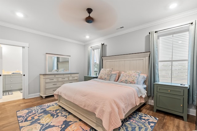 bedroom with ceiling fan, ornamental molding, and dark hardwood / wood-style flooring