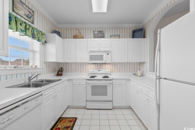 kitchen featuring light tile patterned flooring, sink, white cabinets, and white appliances