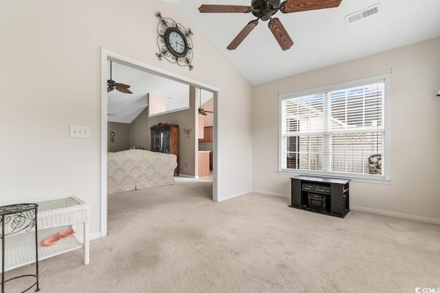 interior space with carpet, visible vents, vaulted ceiling, and baseboards