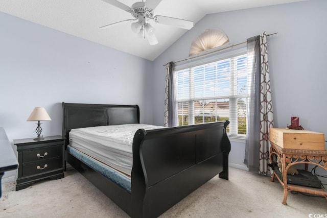 bedroom with light carpet, vaulted ceiling, and a ceiling fan