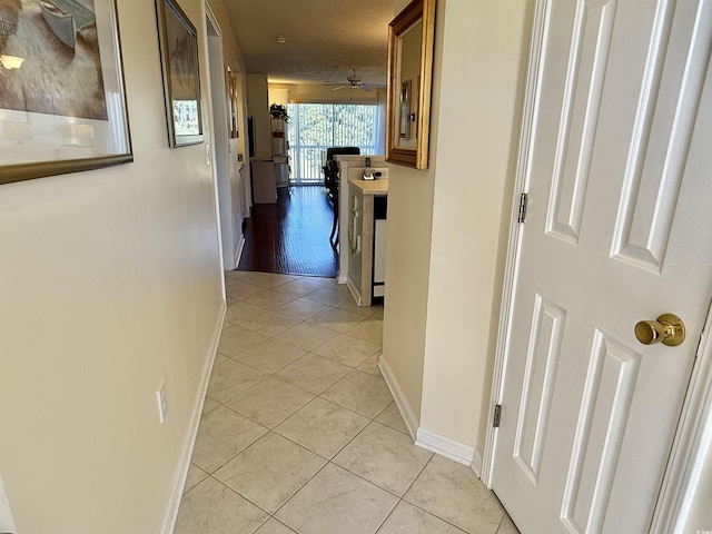 hall featuring light tile patterned flooring