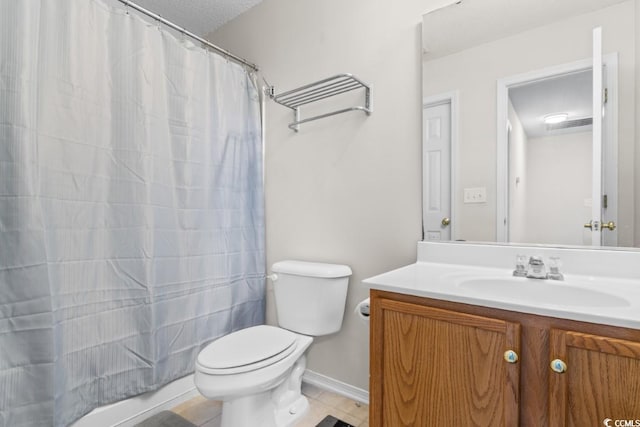 bathroom featuring tile patterned floors, toilet, vanity, and a textured ceiling