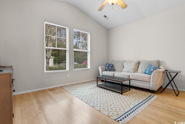 living room featuring lofted ceiling, ceiling fan, and light hardwood / wood-style flooring