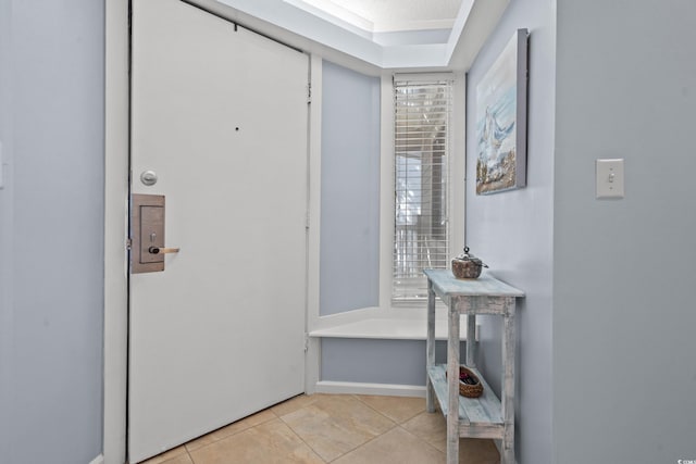 interior space with light tile patterned floors and baseboards