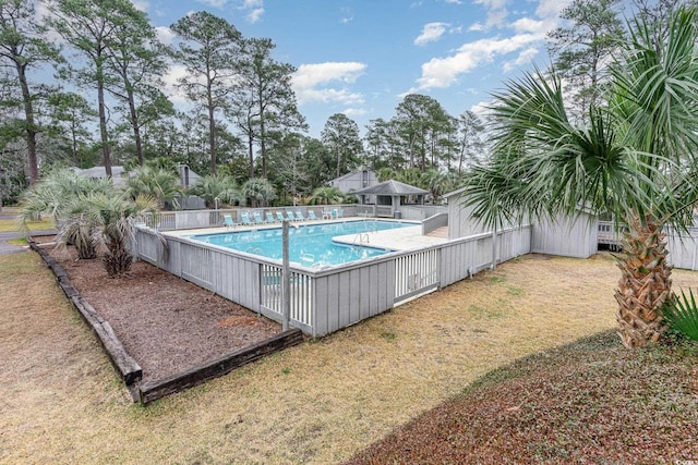 view of pool with a lawn