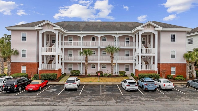 view of property featuring uncovered parking