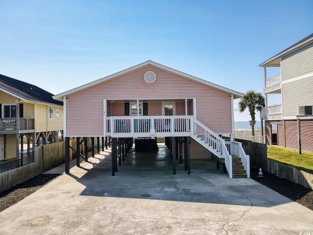 beach home with a carport, driveway, and a porch