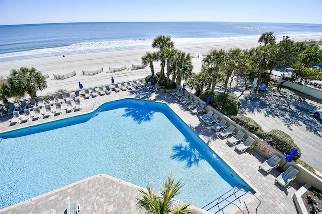 bird's eye view featuring a water view and a beach view