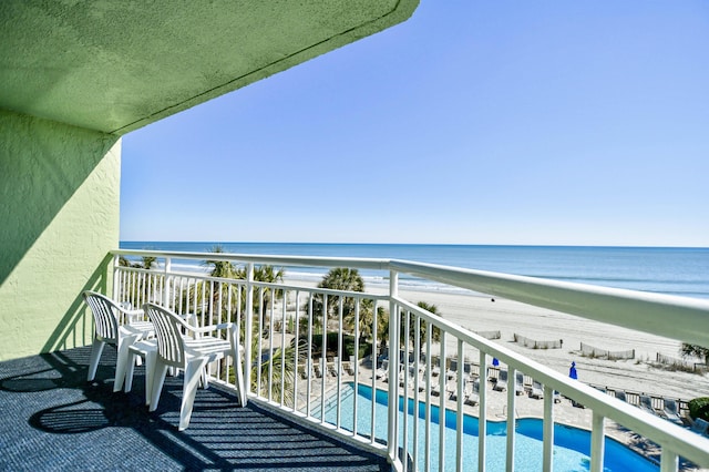 balcony featuring a beach view and a water view