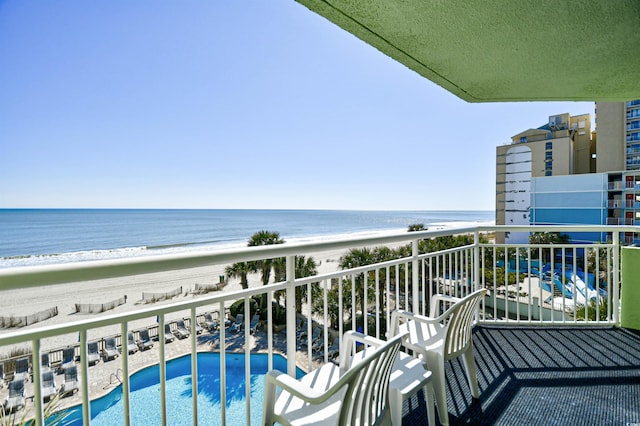 balcony with a beach view and a water view