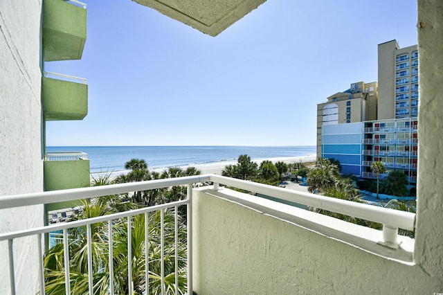 balcony featuring a view of the beach and a water view