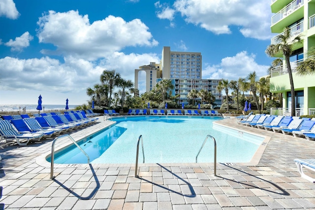 pool featuring a view of city and a patio area