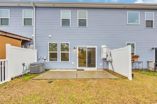 rear view of house featuring a lawn, a patio area, and central air condition unit