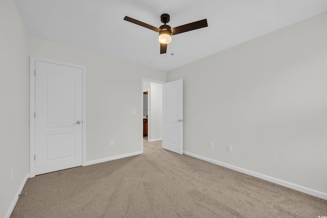 unfurnished bedroom featuring light colored carpet and ceiling fan