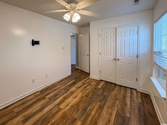 920 Leather Leaf Ln, Longs, SC 29568 - unfurnished bedroom featuring baseboards, dark wood-type flooring, a closet, and a ceiling fan