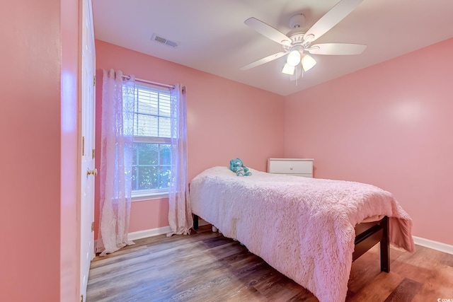 bedroom featuring hardwood / wood-style floors and ceiling fan