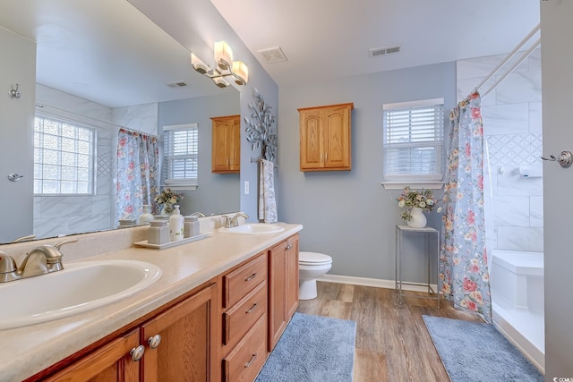 bathroom featuring vanity, hardwood / wood-style floors, toilet, and a shower with shower curtain