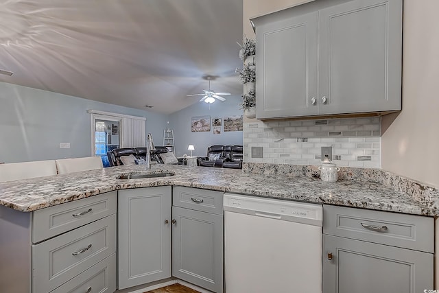 920 Leather Leaf Ln, Longs, SC 29568 - kitchen featuring white dishwasher, a sink, gray cabinets, a peninsula, and decorative backsplash