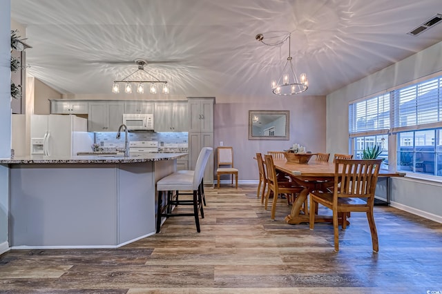 920 Leather Leaf Ln, Longs, SC 29568 - dining area with a chandelier, wood finished floors, and baseboards