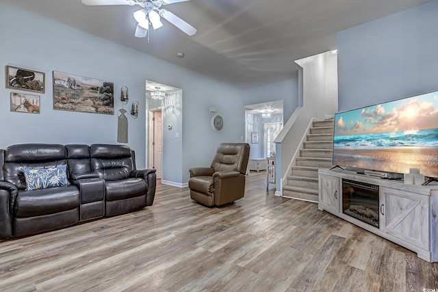 living room featuring light hardwood / wood-style flooring and ceiling fan