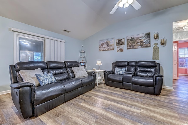 living room with hardwood / wood-style flooring, ceiling fan, and vaulted ceiling