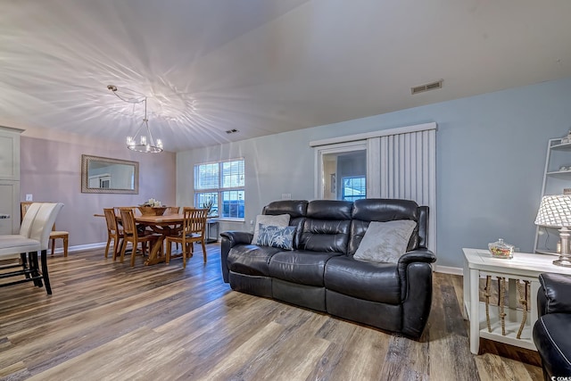 living room featuring an inviting chandelier and hardwood / wood-style flooring