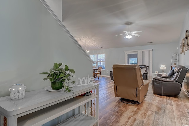 living room featuring ceiling fan and light wood-type flooring