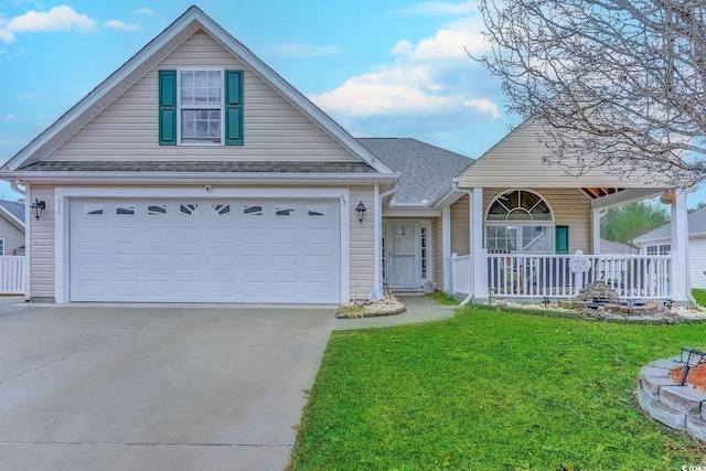 view of front facade with a porch, a garage, concrete driveway, roof with shingles, and a front yard