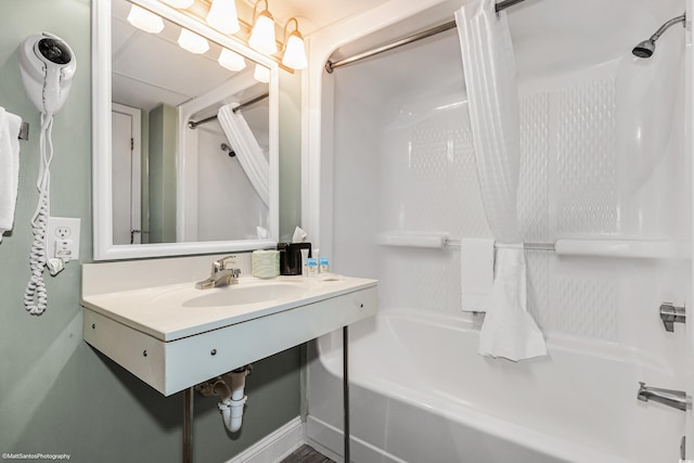 bathroom with shower / tub combo and sink