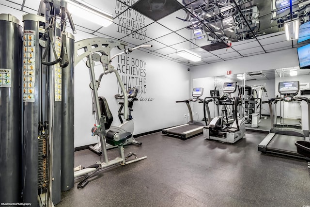 gym with a paneled ceiling