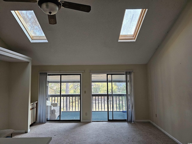 unfurnished living room with lofted ceiling, light colored carpet, and baseboards