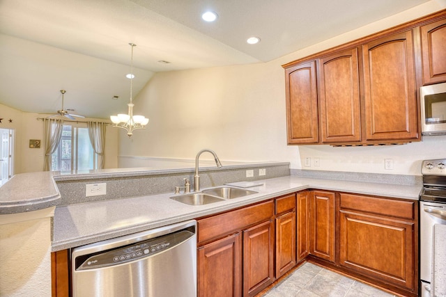 kitchen featuring a peninsula, stainless steel appliances, light countertops, pendant lighting, and a sink