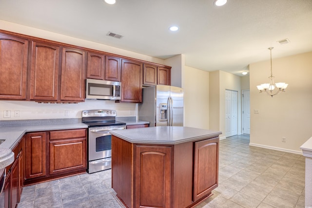 kitchen featuring visible vents, a kitchen island, appliances with stainless steel finishes, an inviting chandelier, and pendant lighting