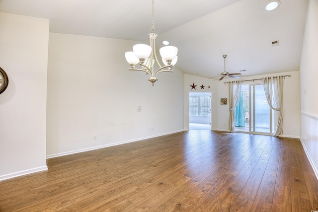 empty room with ceiling fan with notable chandelier, visible vents, baseboards, and wood finished floors