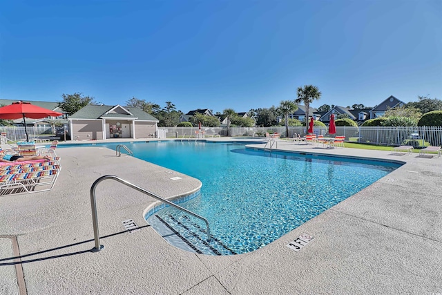 pool featuring a patio area and fence