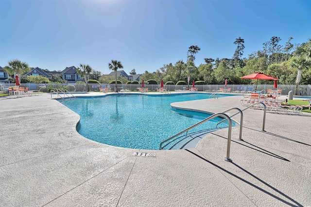 pool with fence and a patio