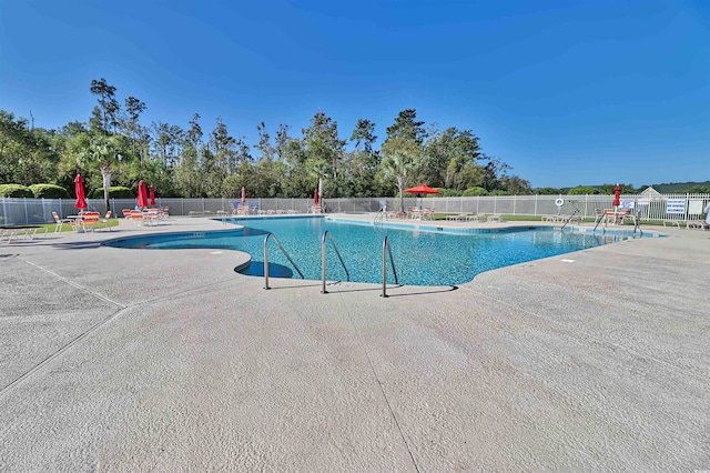 pool featuring a patio and fence