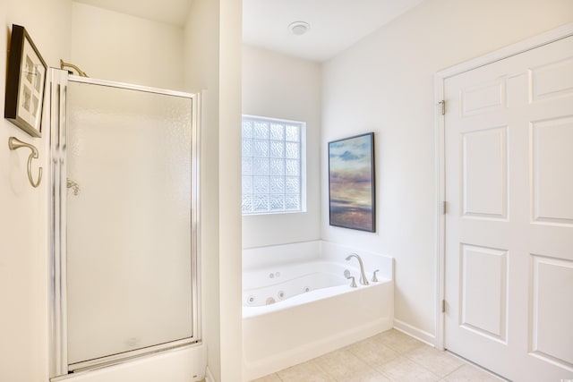 full bath featuring a whirlpool tub, a shower stall, baseboards, and tile patterned floors