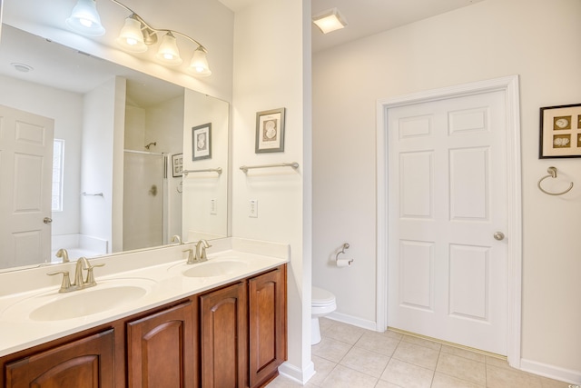 bathroom featuring a stall shower, a sink, toilet, and tile patterned floors