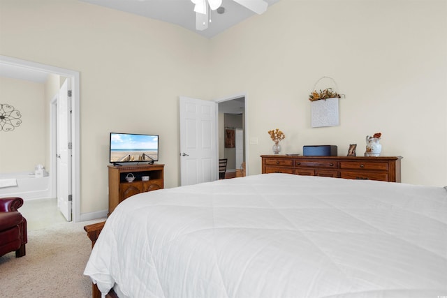 carpeted bedroom featuring ceiling fan and connected bathroom