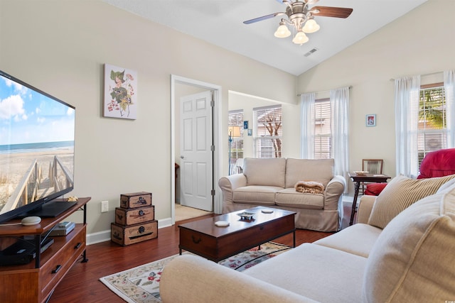 living room featuring dark wood-type flooring, ceiling fan, lofted ceiling, and a wealth of natural light